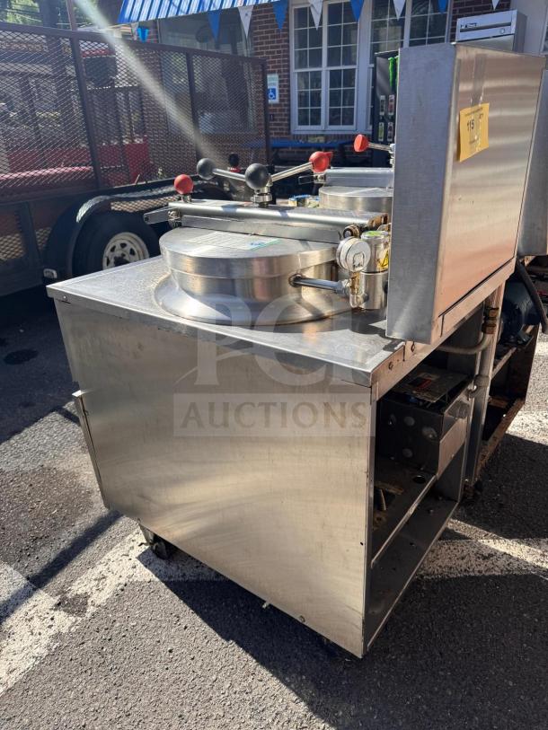 BKI FKM-FC commercial electric pressure fryer, 208 volts, stainless steel, visible wear, outdoor setting.