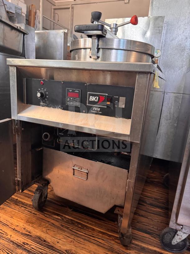 BKI FKM-F commercial electric pressure fryer, 208V, stainless steel, with control panel, used condition, on wheels.