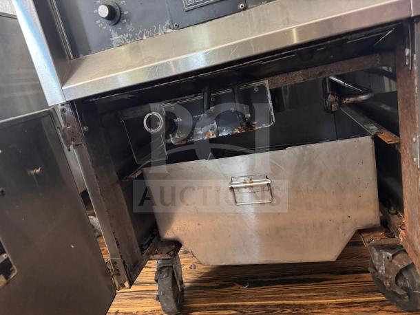 BKI FKM-F commercial electric pressure fryer, 208 volts, features visible wear and rust, control panel and interior visible.