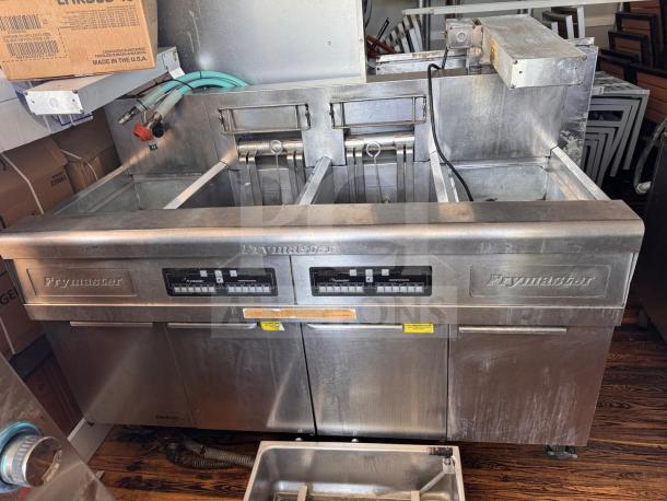 Frymaster FMRE222CSC double electric fryer with two dump stations, stainless steel, visible control panels, used condition.