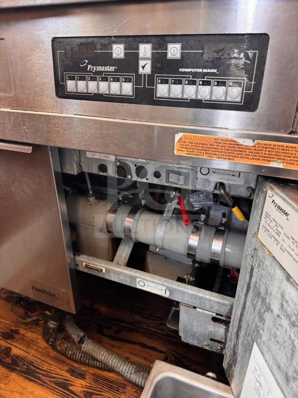 Frymaster FMRE222CSC double electric fryer with control panel, two dump stations, stainless steel, warning label visible.