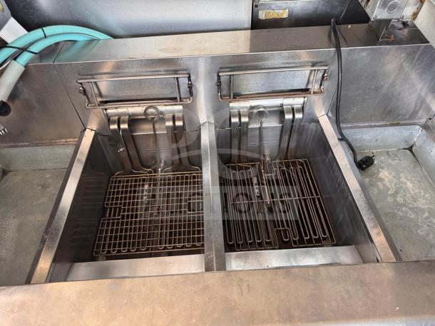 Frymaster FMRE222CSC double electric fryer with two dump stations, stainless steel finish, clean condition, visible heating elements.