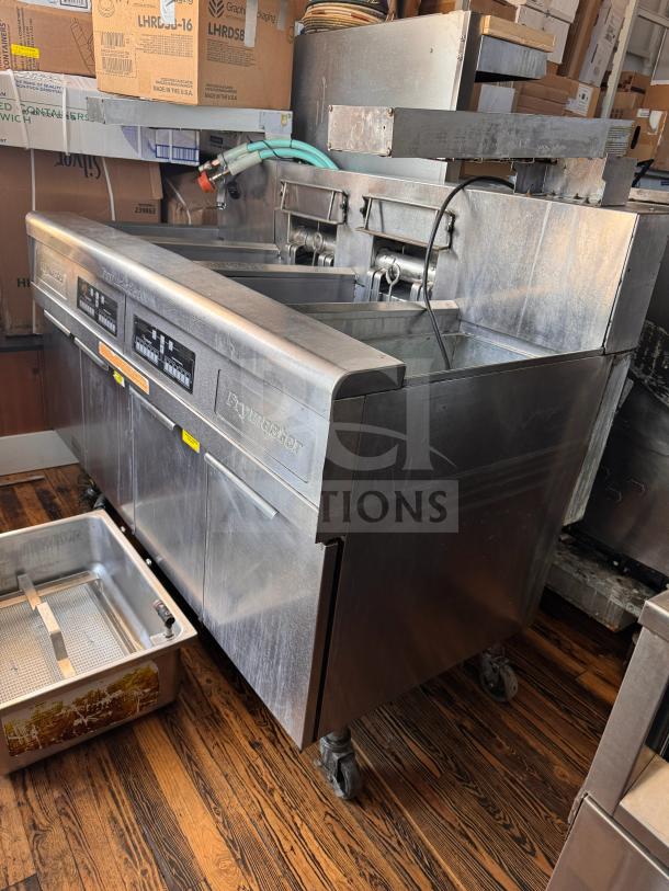 Frymaster FMRE222CSC Double Electric Fryer with two dump stations, stainless steel, commercial kitchen equipment, on casters.