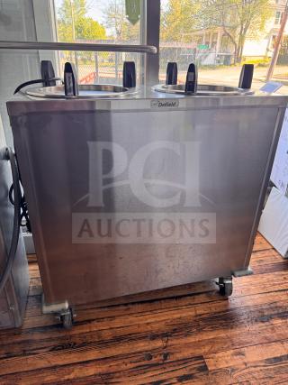 Delfield CAB2-1200ET Mobile Two Stack Dish Dispenser, stainless steel, on wheels, visible Delfield logo, sturdy condition.