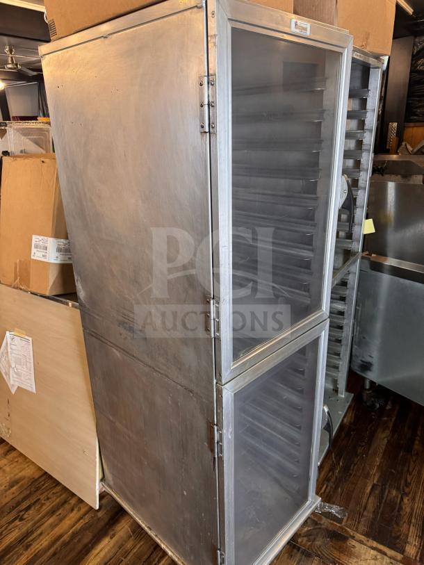 Stainless steel sheet pan cabinet with transparent doors, multiple shelves, and visible industrial hinges. Good condition.