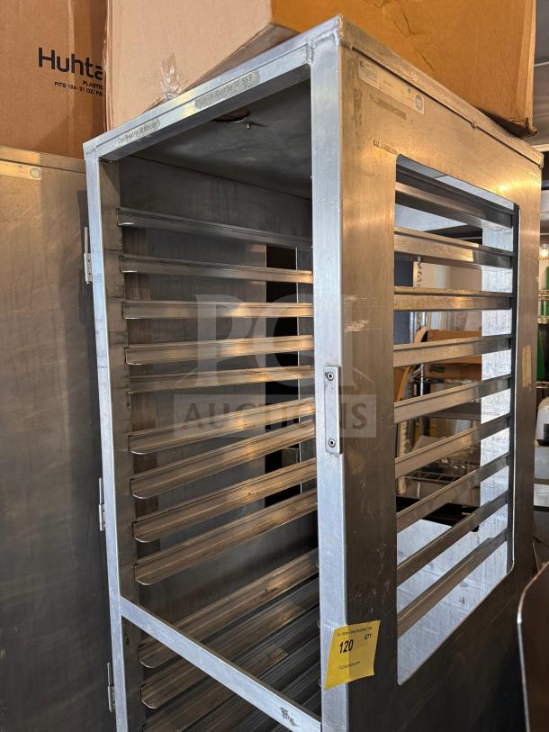 Stainless steel sheet pan rack with multiple slots, labeled "120," in used condition, ideal for commercial kitchens.