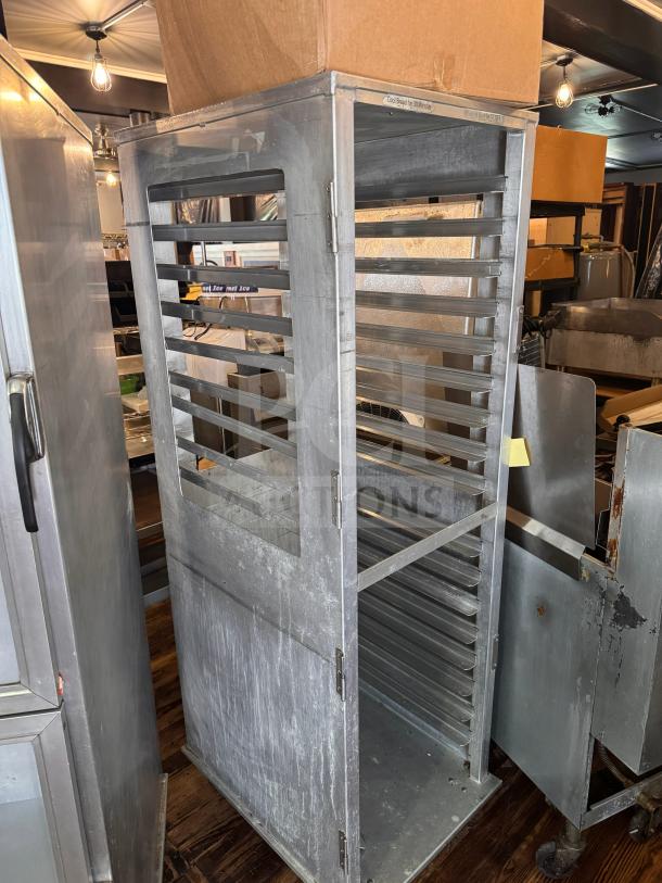 Metal sheet pan rack with multiple slots, used condition, labeled "Cool Bread for 30 Minutes," ideal for bakery use.
