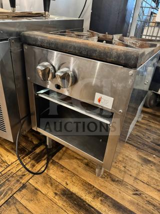 CPG natural gas stock pot range with dual knobs, steel body, and visible storage. Shows some wear, CPG logo visible.