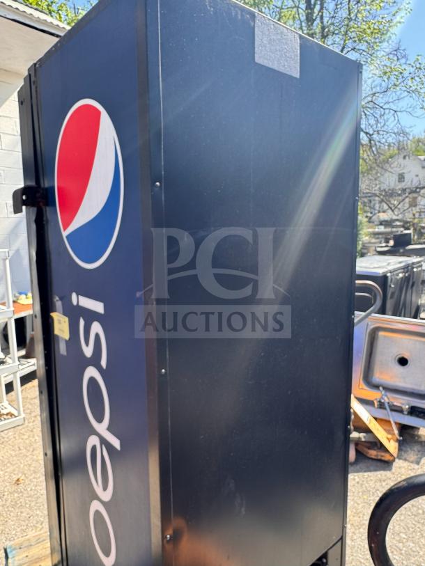 Pepsi vending machine with logo, missing key, blue exterior, some visible wear, suitable for parts or refurbishing.