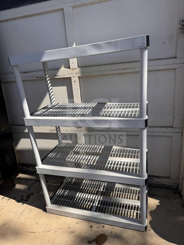 Plastic storage shelving unit with three ventilated shelves, white color, sturdy and ideal for garage or utility use.