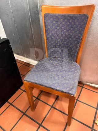 Wooden dining side chair with blue patterned upholstery. Features a curved backrest and square legs. Appears in good condition.
