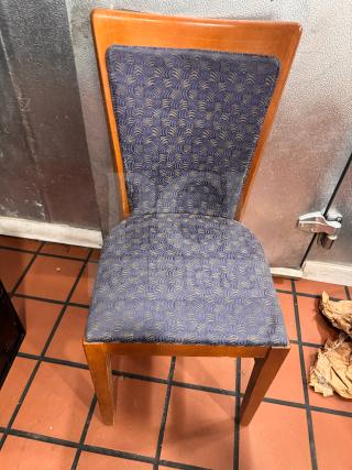 Dining side chair featuring a wooden frame and blue patterned fabric upholstery. Good condition.