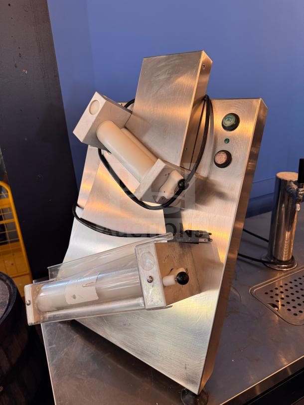 Doyon DL12DP countertop dough sheeter, stainless steel body, dual roller system, well-maintained, for efficient dough processing.