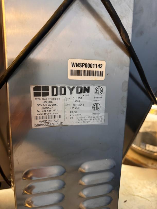 Doyon DL12DP countertop dough sheeter, stainless steel, model label showing specs: 120V, 60Hz, 370W, made in Italy.