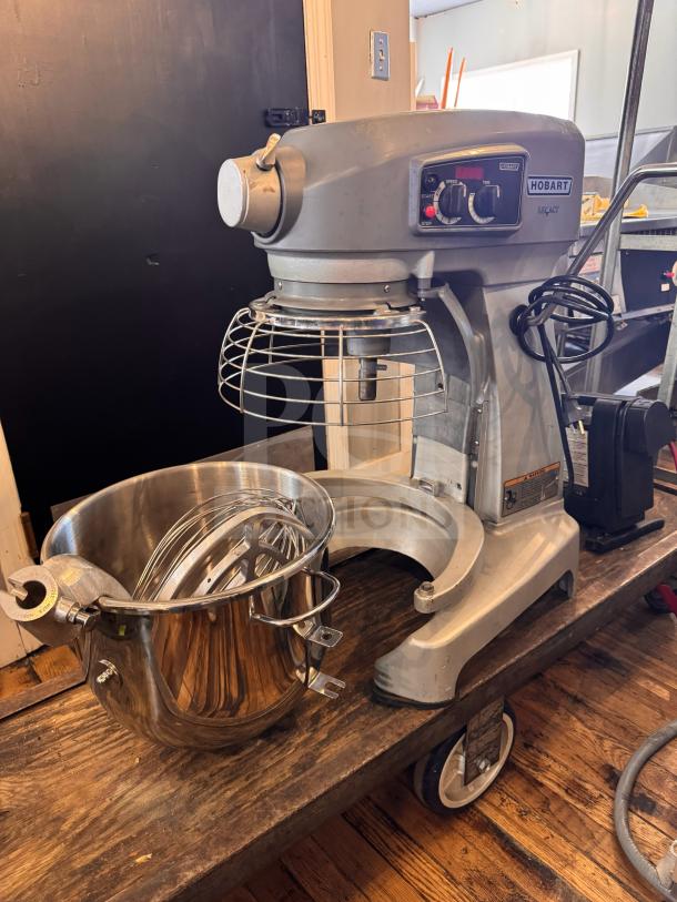 Hobart HL200 Legacy 20-Quart mixer with crack on right side; tested working; includes bowl and attachments.