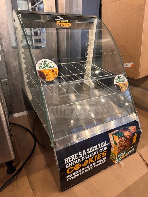 Glass and metal cookie display case with "Try Our Favorite Cookies" signage, good condition, promotional branding visible.