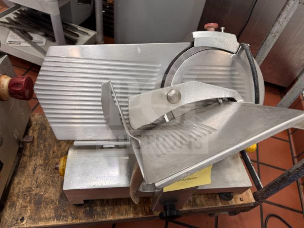 Fleetwood 412 Slicer, tested and working, metal construction, adjustable blade, clean condition, visible control knobs.
