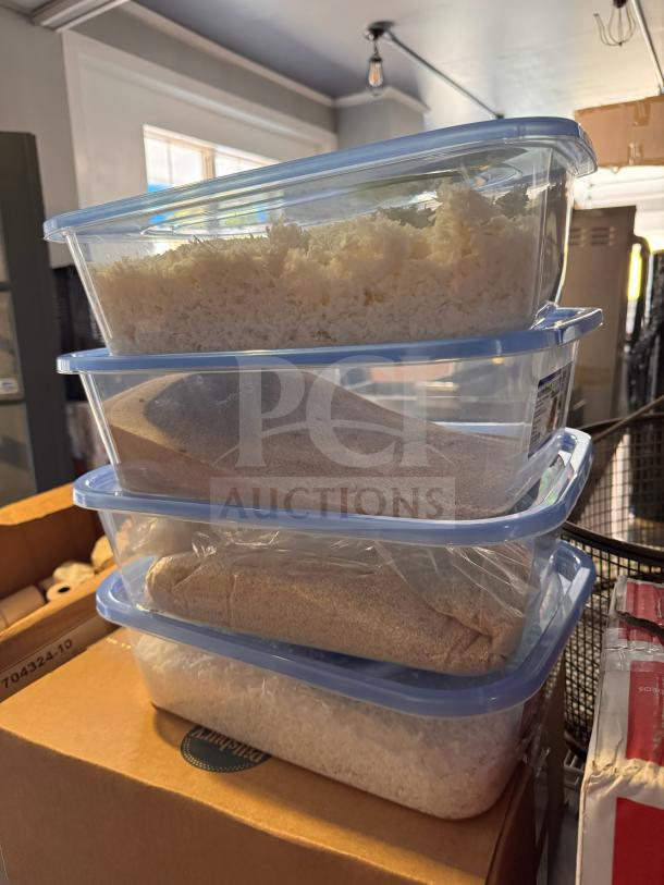 Stack of clear plastic storage food containers with blue lids, containing various grains and rice.