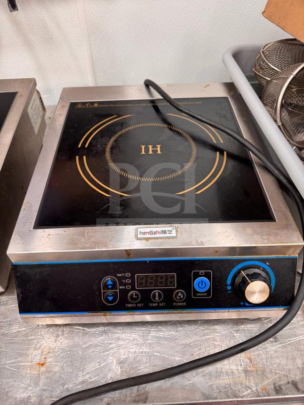henGzhi IC-35A induction cooker with digital controls, visible logo, used condition, stainless steel and black finish.