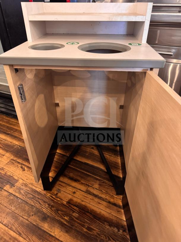 Wooden waste receptacle with dual openings, labeled for recycling and trash. Features a cabinet, shelf, and sturdy base.