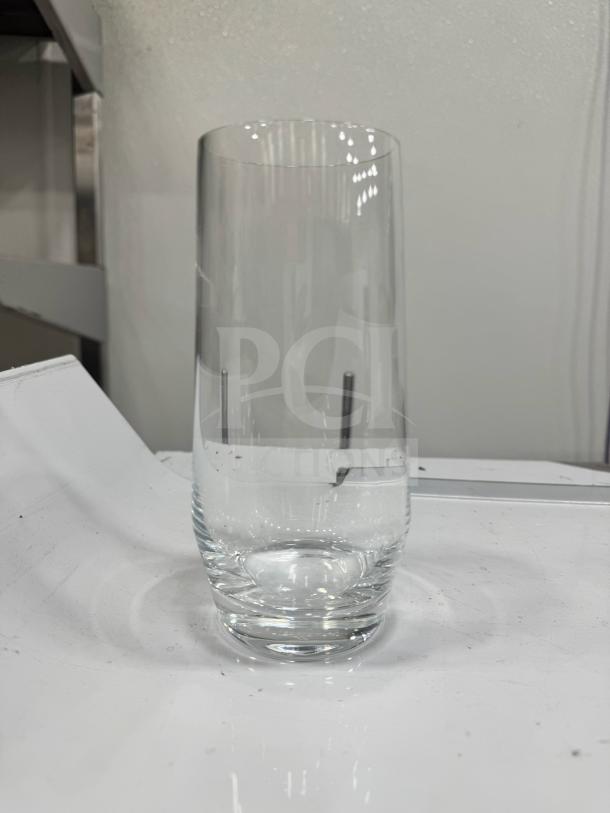 Clear long drink glass with a sleek cylindrical design, in pristine condition, set on a white background.