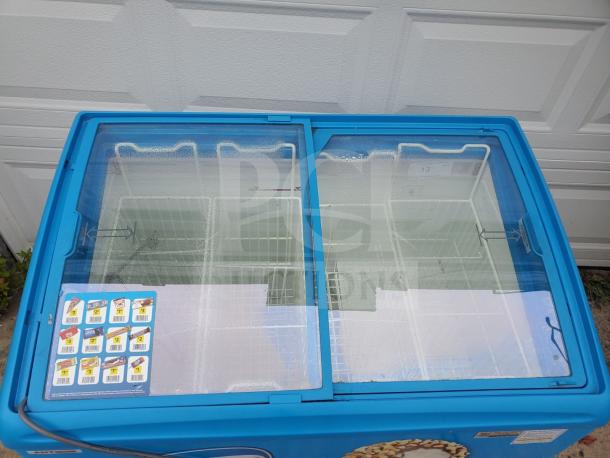 AHT RIO S 100 sliding glass top 2 door ice cream freezer merchandiser, blue, used condition, with product labels.