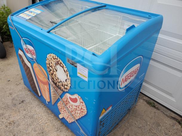 AHT RIO S 100 sliding glass top ice cream freezer with Nestlé branding, good condition, blue exterior with ice cream graphics.