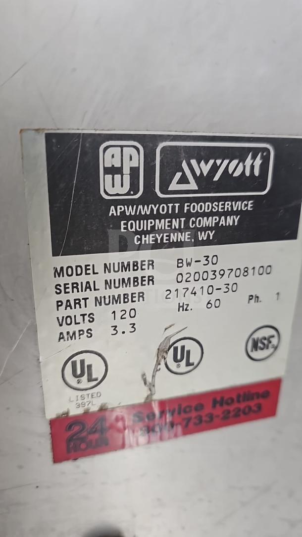 APW Wyott BW-30 commercial hot food warmer drawer label, showing model and serial number, 120 volts, 3.3 amps, UL and NSF certifications.
