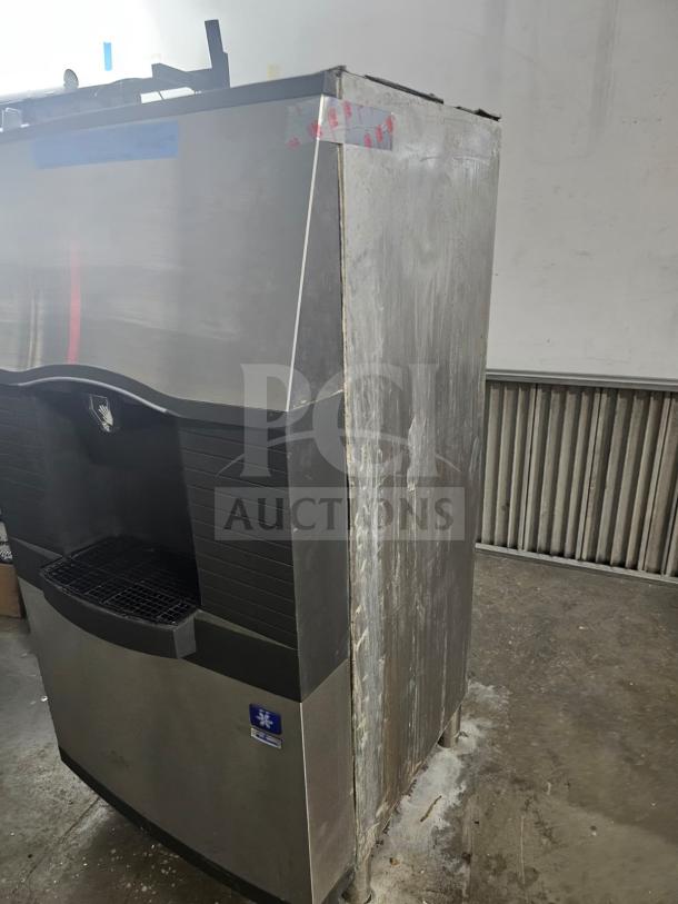 Manitowoc SPA310 ice dispenser with 180-lb storage, used condition, visible wear, stainless steel finish, logo on front panel.