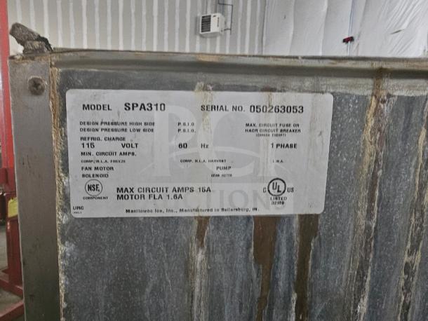 Manitowoc SPA310 ice dispenser with 180-lb storage, visible label with model and serial number. Worn exterior condition.