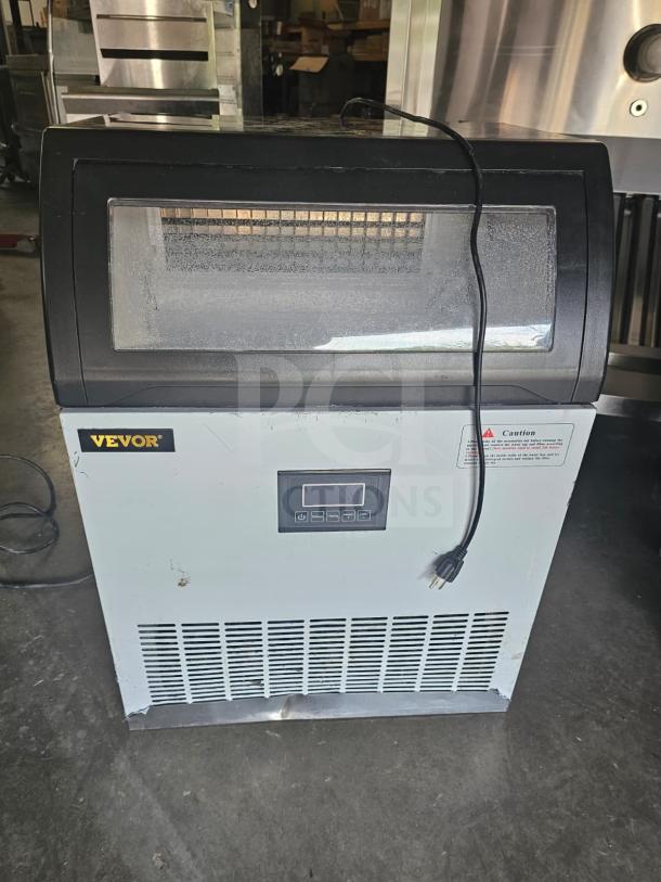 VEVOR SKF-E120F commercial ice maker, silver with digital display, visible power cord, gently used condition.