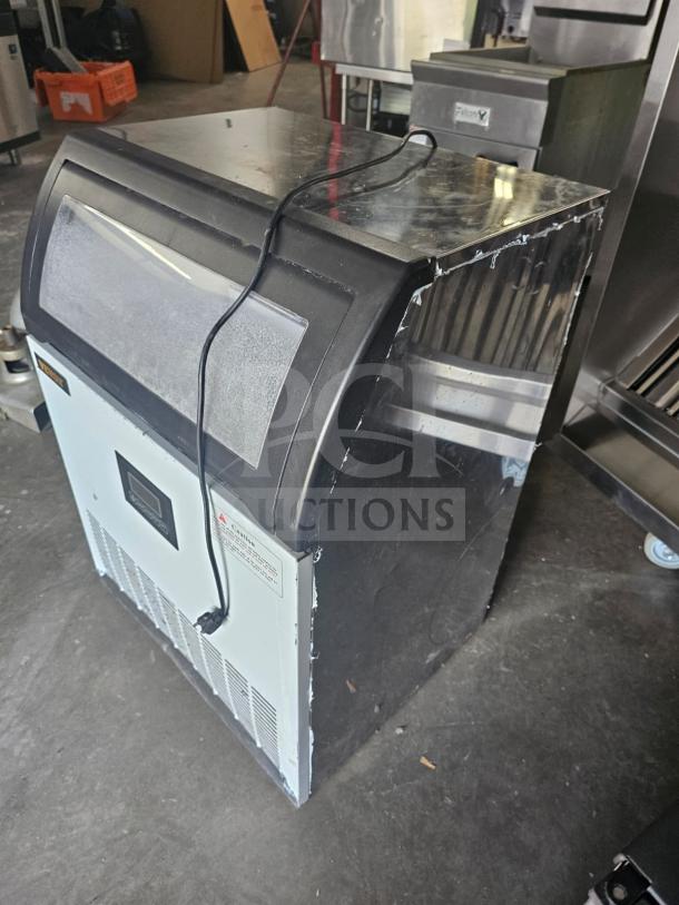 VEVOR SKF-E120F commercial ice maker, black and silver, visible cable, slight wear on edges, warning label on front.