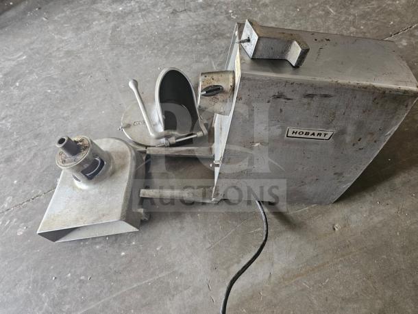 Hobart commercial food processor in used condition, featuring a metal build with visible wear and the Hobart brand label.