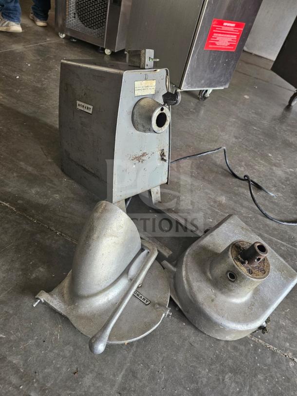 Hobart commercial food processor, metal finish, used condition, visible wear, brand plate intact, with attachments.