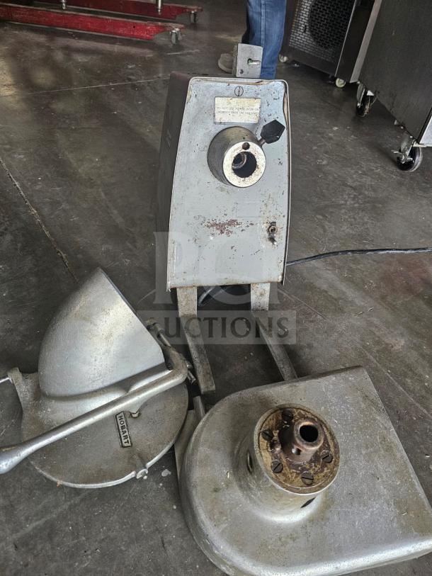 Hobart Commercial Food Processor, gray metal, used condition, includes attachments, visible wear and labeling.