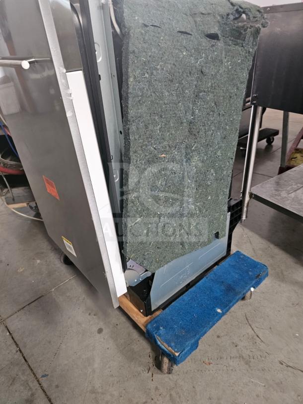 Honeywell residential dishwasher, partially disassembled, exposed insulation, visible wiring, on a rolling dolly.