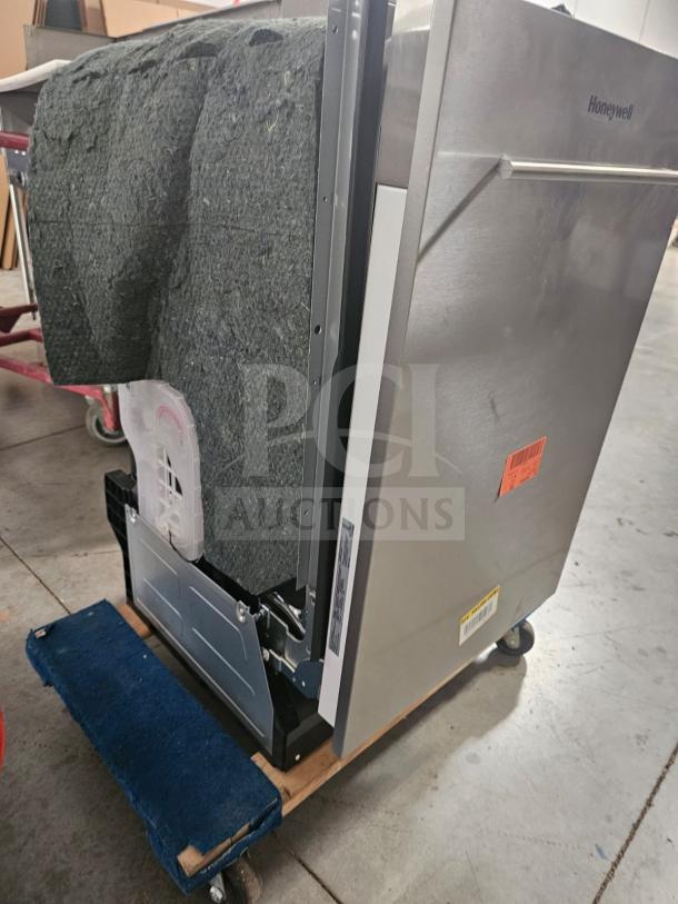 Honeywell residential dishwasher, stainless steel, side view, visible insulation, freight tags, and model label on bottom.
