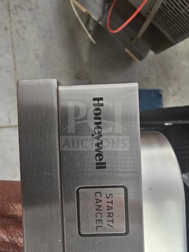 Honeywell residential dishwasher with stainless steel finish, featuring a Start/Cancel button.