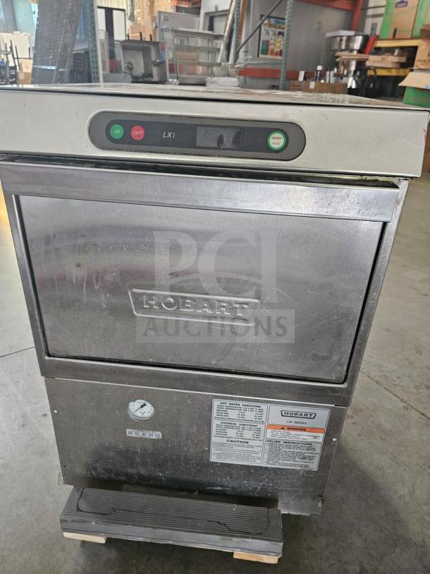 Hobart XLI commercial undercounter dishwasher, stainless steel, visible control panel, labels with operating instructions.