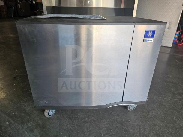 Manitowoc SD0452A commercial ice machine, stainless steel, 115V, on wheels, good condition, visible branding on front.