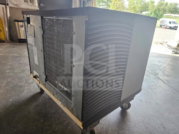 Manitowoc SD0452A commercial ice machine, 115V, showing side vents and metal casing, on wheels, in good condition.