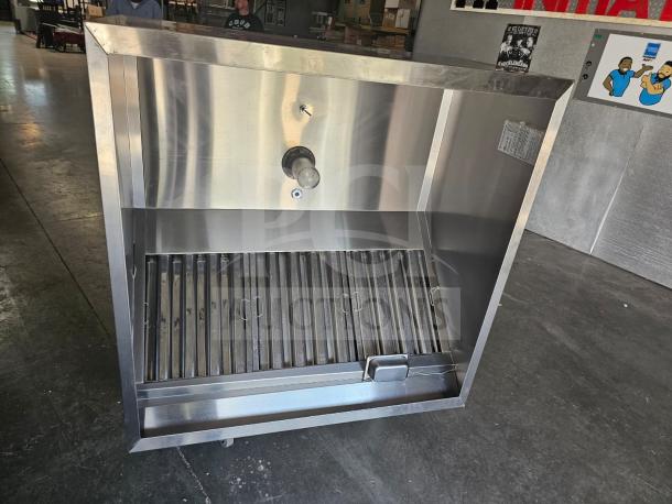 Commercial stainless steel exhaust hood, model XBEW-48.00-S, with slatted filters and wall-mount design, excellent condition.