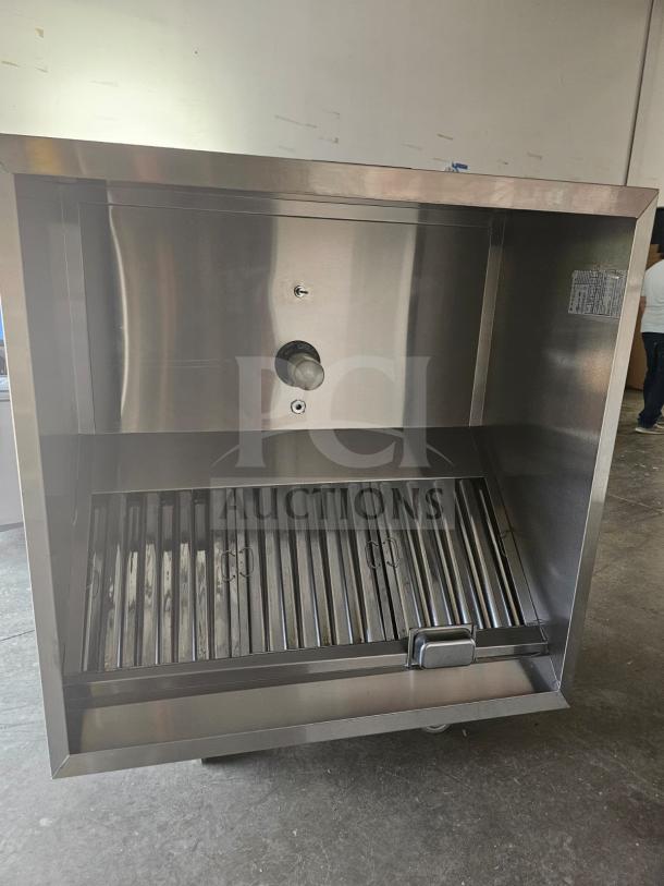 Commercial stainless steel exhaust hood, model XBEW-48.00-S. Features a grease filter and mountable design. Excellent condition.