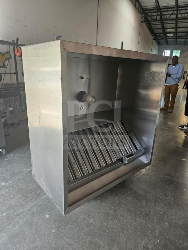 Commercial stainless steel exhaust hood, model XBEW-48.00-S, in excellent condition, with integrated lighting and baffle filters.