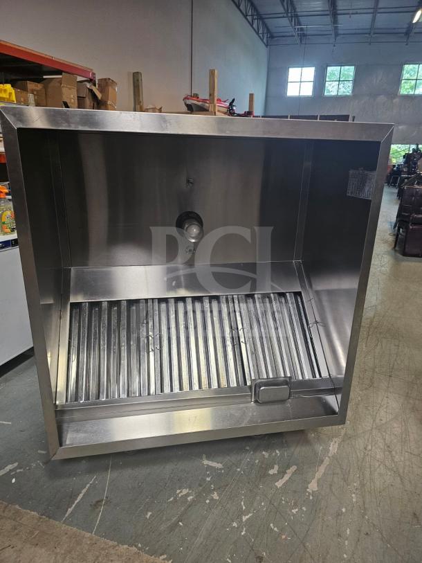 Commercial stainless steel exhaust hood, model XBEW-48.00-S, with baffle filters. Appears in excellent condition.