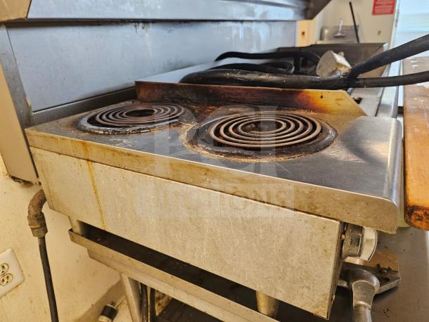 STAR MAX 2-burner electric cooktop, stainless steel, visible wear, coil burners, used condition, industrial setting.