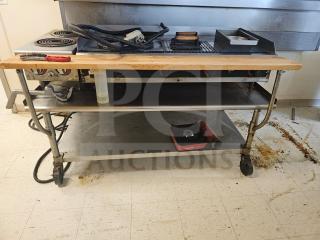 72" stainless steel stand on wheels with two shelves. Used condition, suitable for kitchen or industrial use. Items not included.