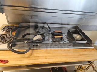48" electric griddle with visible power cable. Features a metal cooking surface, wooden handle presses, and attached grease tray. Used condition.