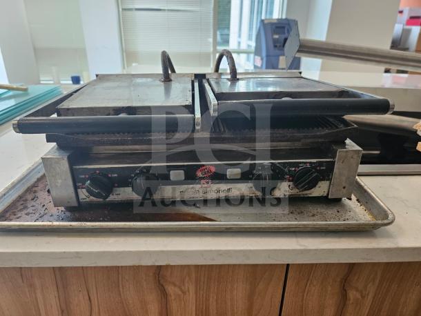 Nuova Simonelli Super Grill Commercial Double-bay panini grill, dual dials, visible wear, ideal for cafes or restaurants.