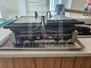 Nuova Simonelli Super Grill Commercial Double-bay panini grill, dual dials, visible wear, ideal for cafes or restaurants.